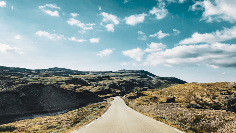 gray concrete road across mountain