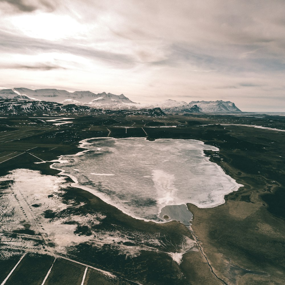 body of water across white mountains