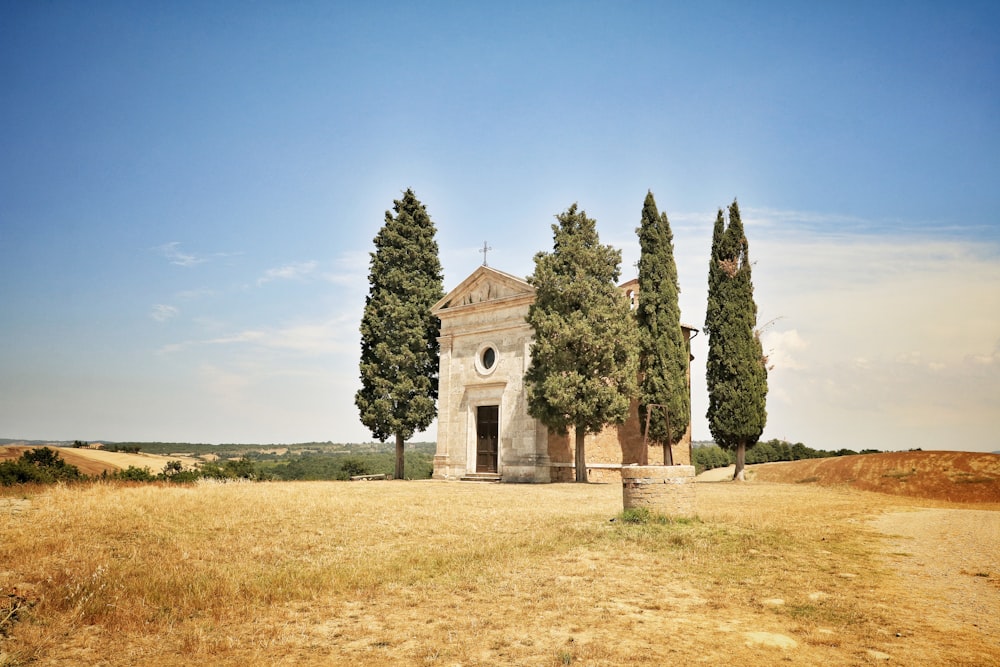 Bâtiment en béton blanc entre des arbres verts