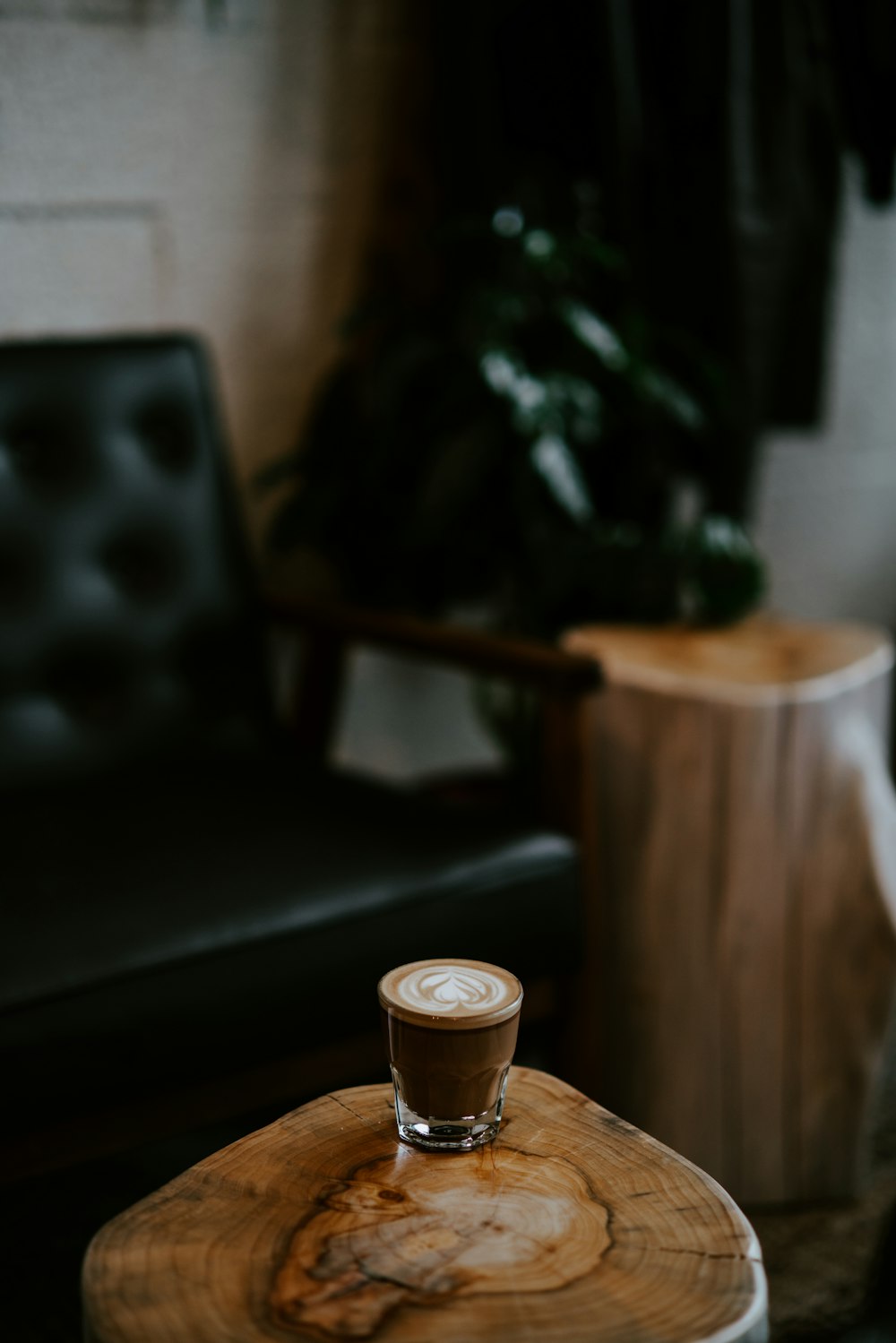 shallow focus photo of drinking glass on brown table