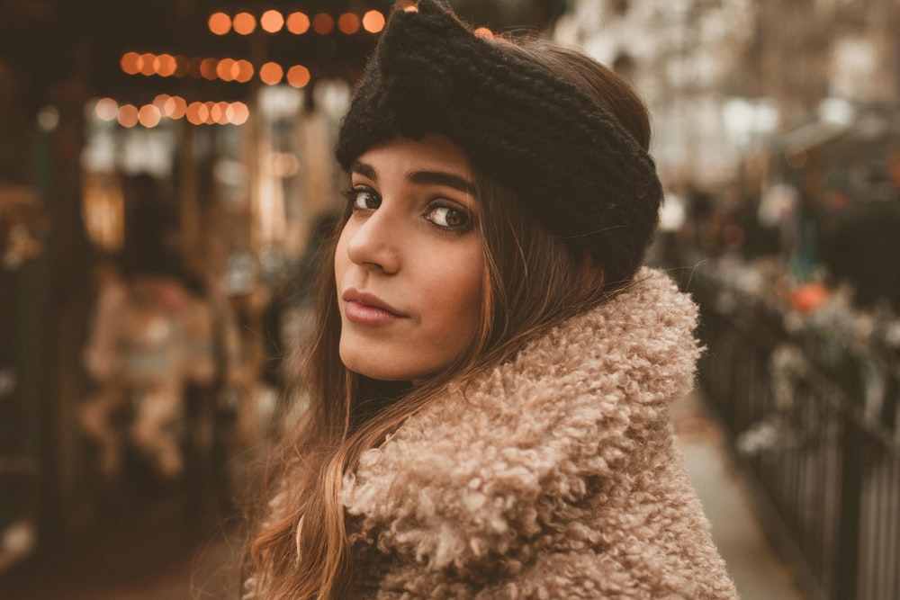 selective focus photography of woman wearing black knit headdress