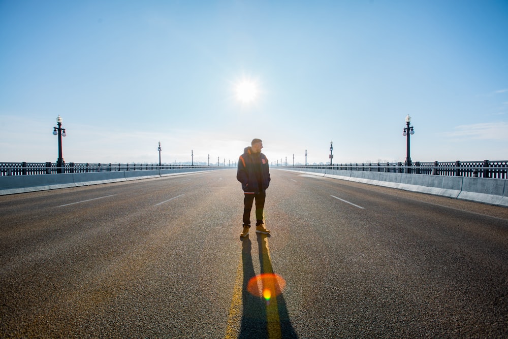 man standing on road