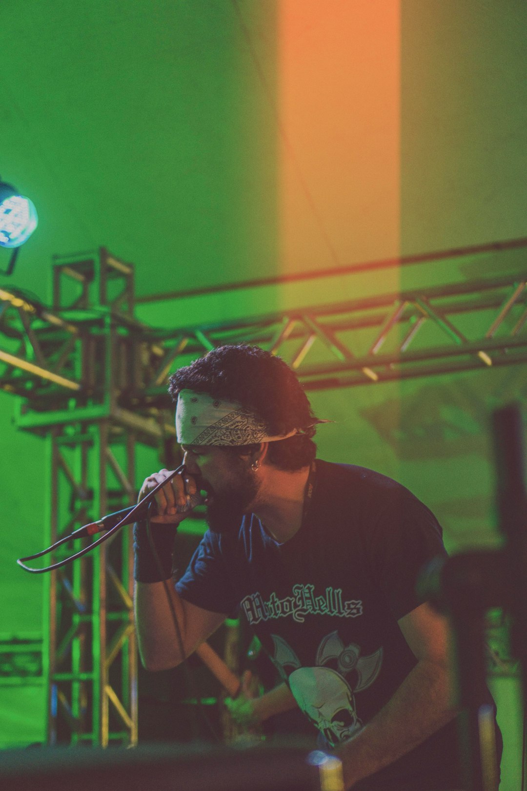 man performing on stage while holding microphone