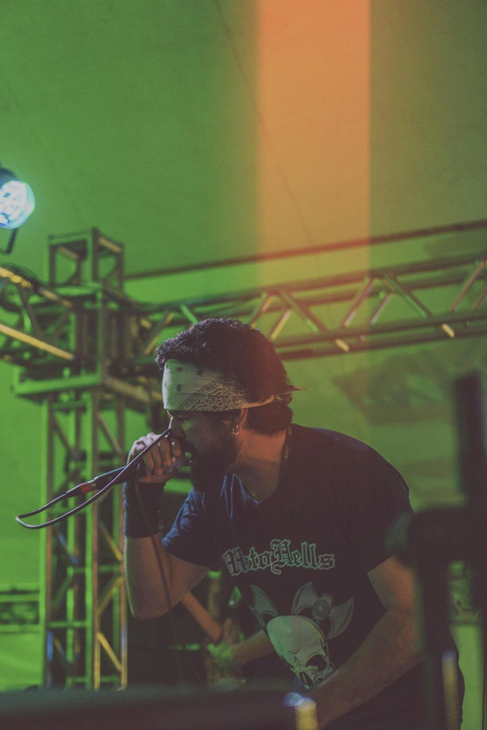 man performing on stage while holding microphone