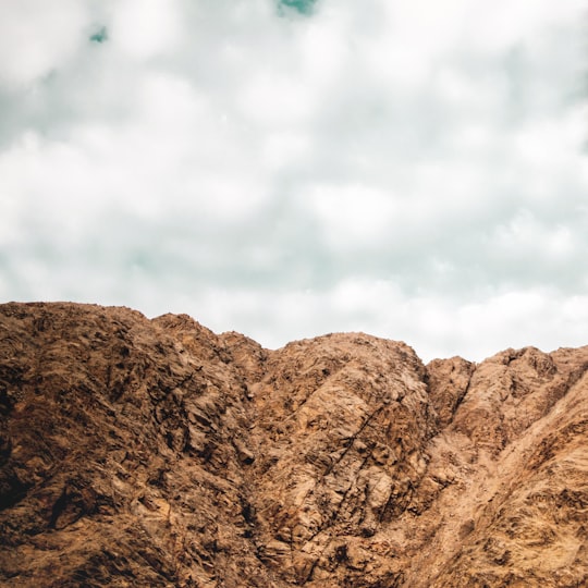 brown mountain under cloudy sky during daytime in Lunahuana - Lima Peru