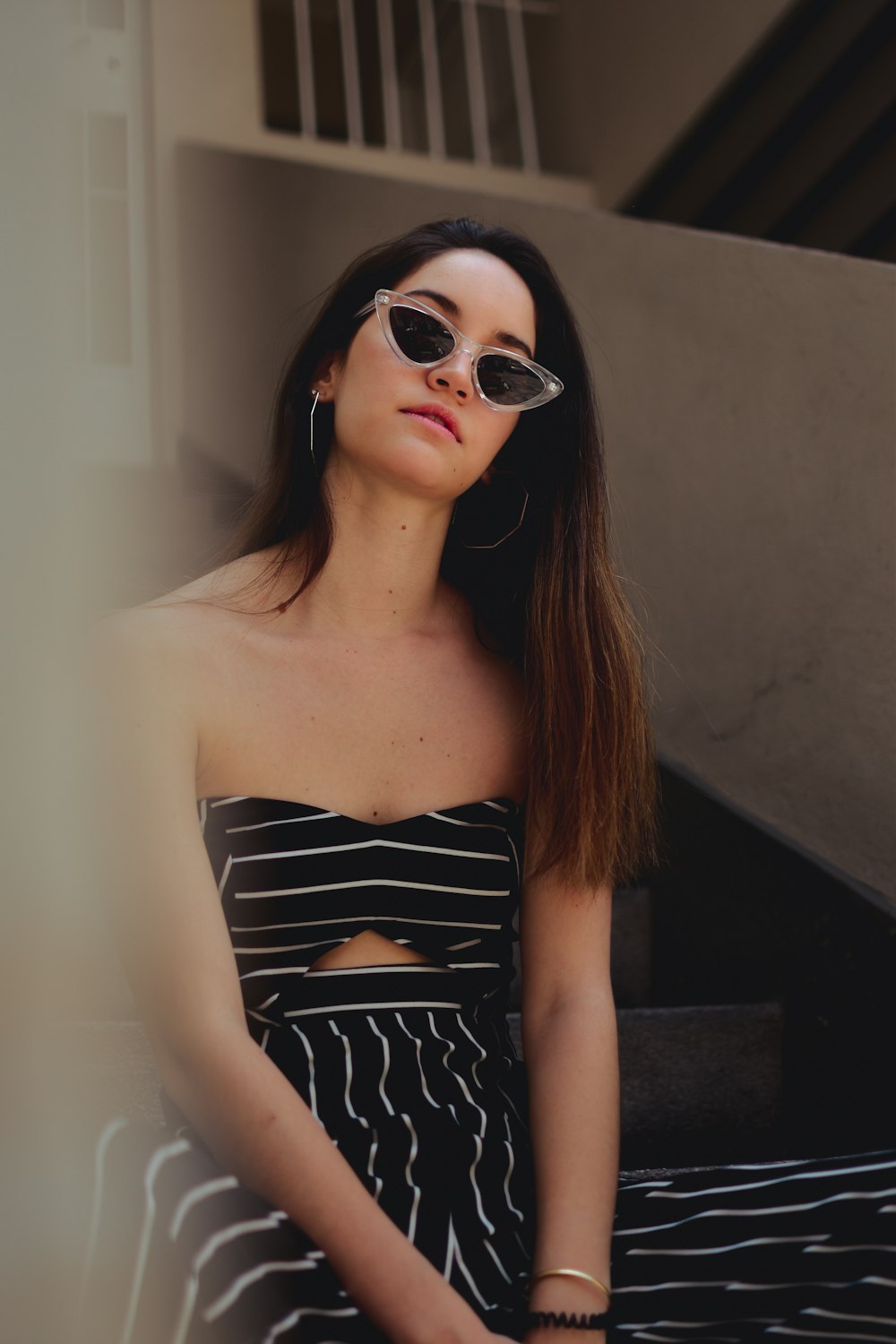 woman wearing sunglasses and black and white striped otp