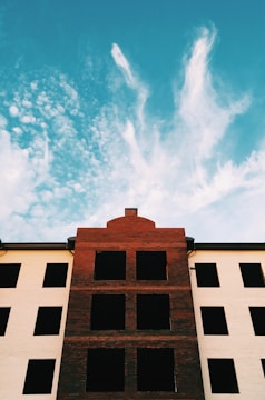 A sturdy brick building under a clear blue sky symbolizing solid property investment.
