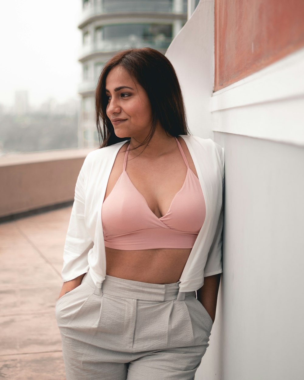 woman waering pink bra and white cardigan