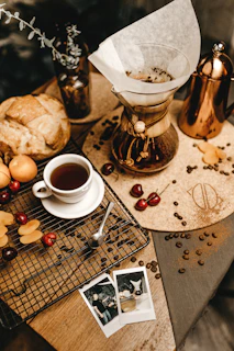 Elegant coffee setup with Chemex and freshly brewed coffee on a wooden table with mountain views.