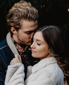 shallow focus photo of man kissing woman