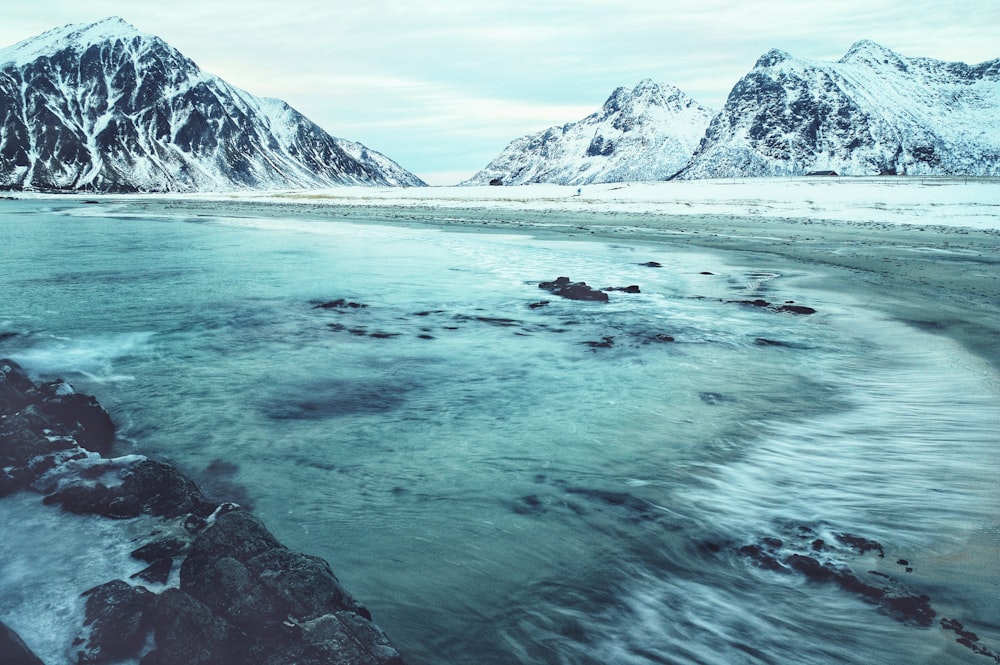 body of water beside mountain