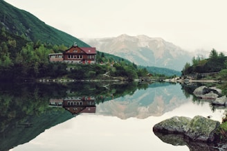 red house near body of water during daytime