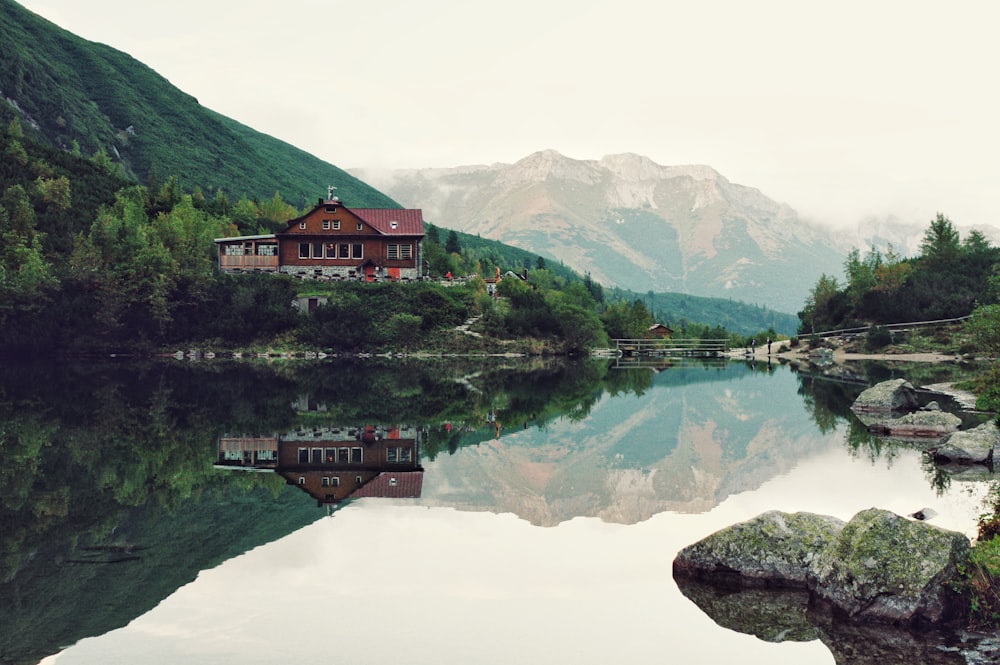 red house near body of water during daytime