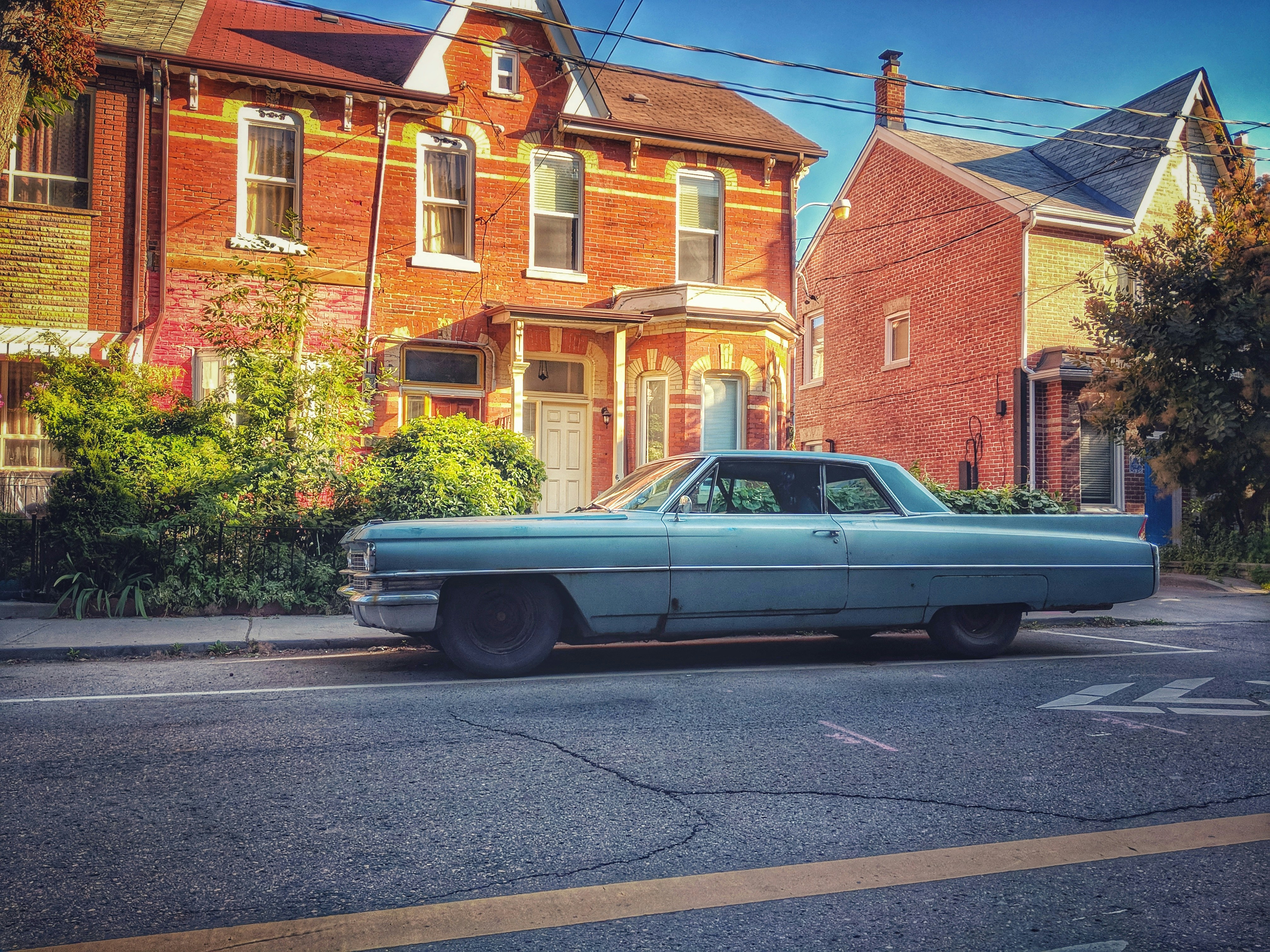 white coupe parked beside building