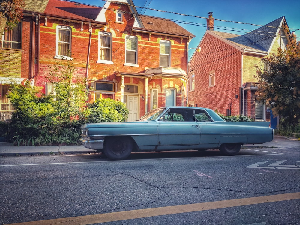 white coupe parked beside building