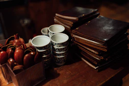 Stacks of menus and flyers ready for distribution on a wooden table.
