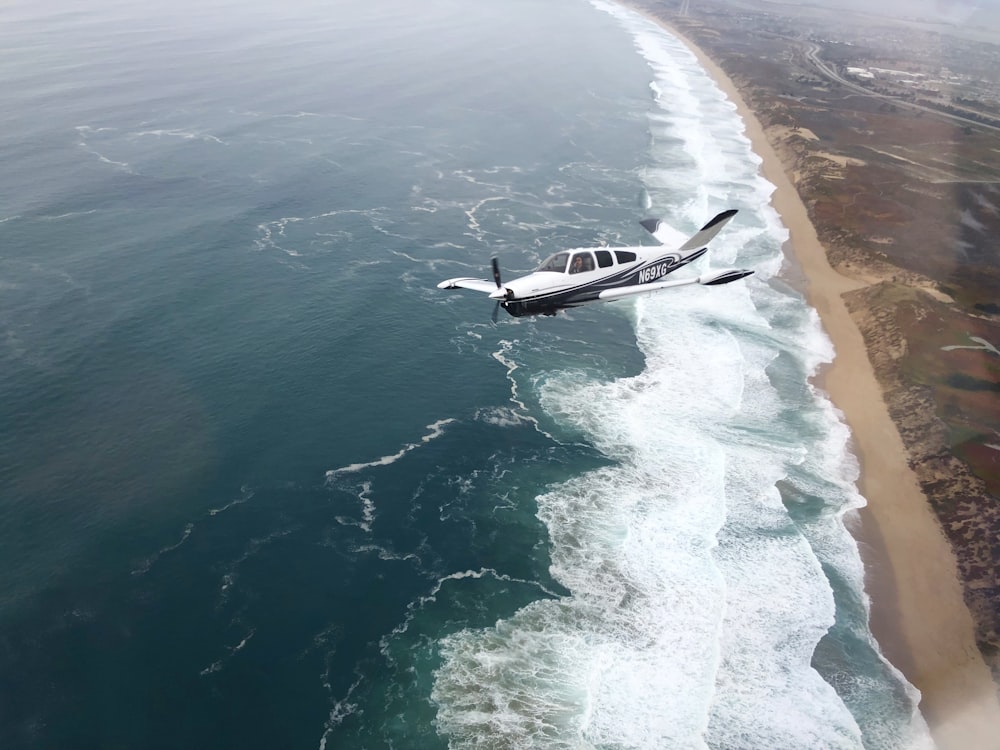 white monoplane on flight during daytime