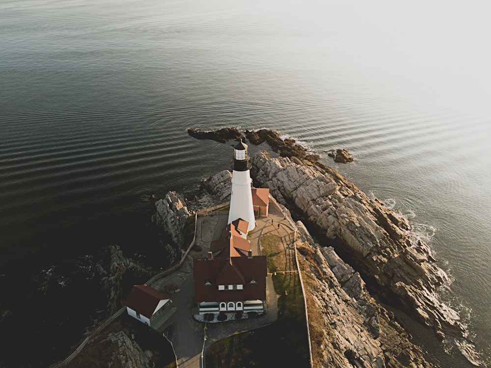 aerial photo of white and brown lighthouse