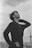 grayscale photography of man touching his leg