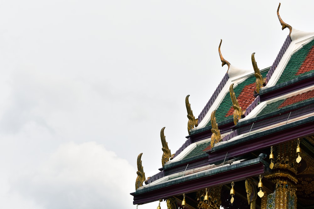 green and gold temple under white cloudy sky