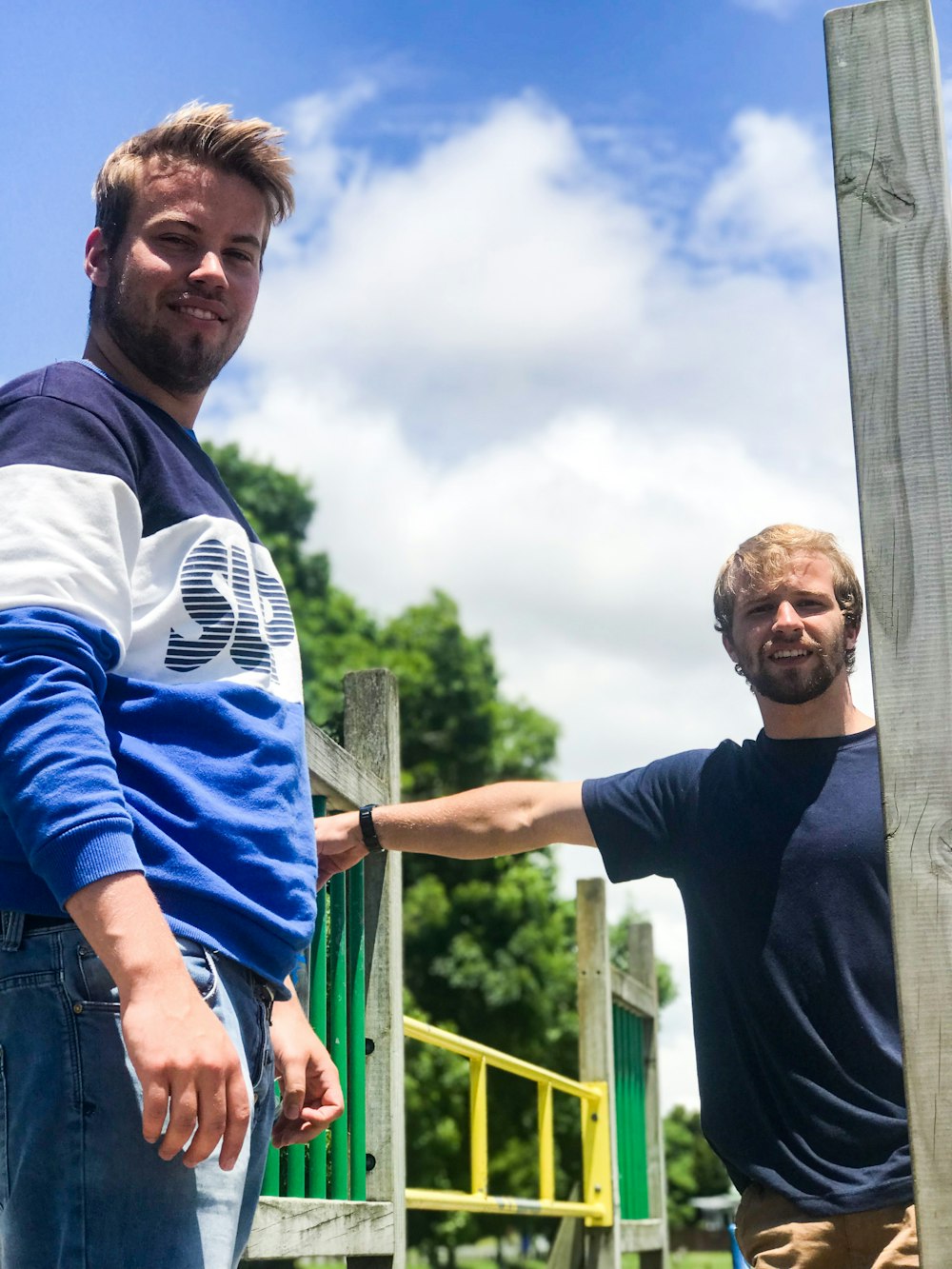 two men standing near rails