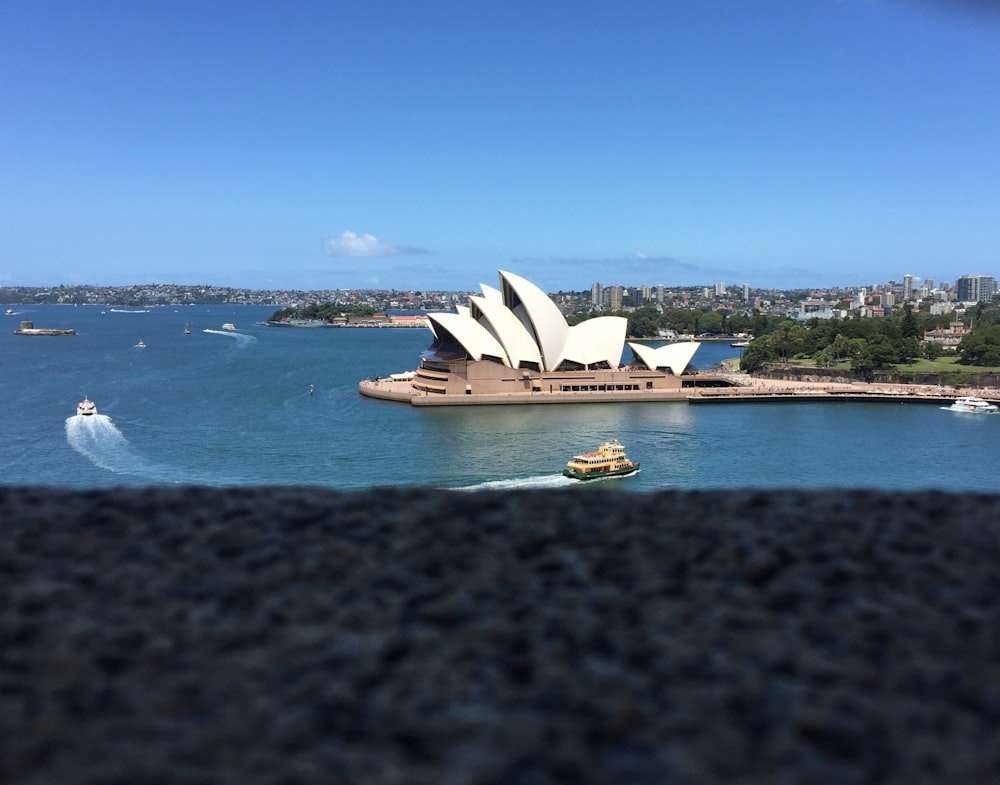 boat on body of water near building at daytime