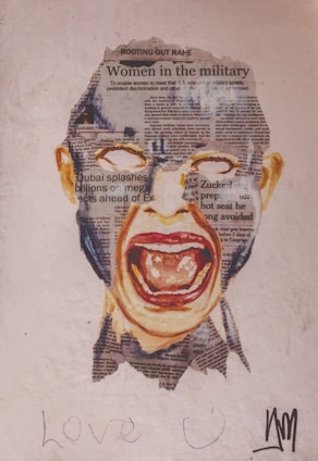 A collage depicting a screaming face overlayed with newspaper clippings. The newspaper features headlines such as 'Women in the military' and 'Rooting out rape.' The background is a plain surface with the words 'Love U' written in the lower part.