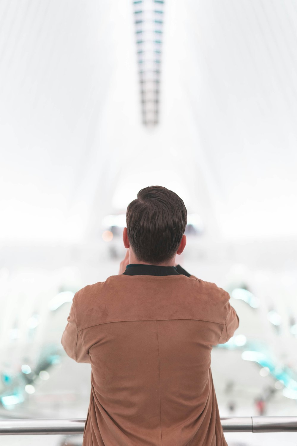 shallow focus photo of person in brown jacket