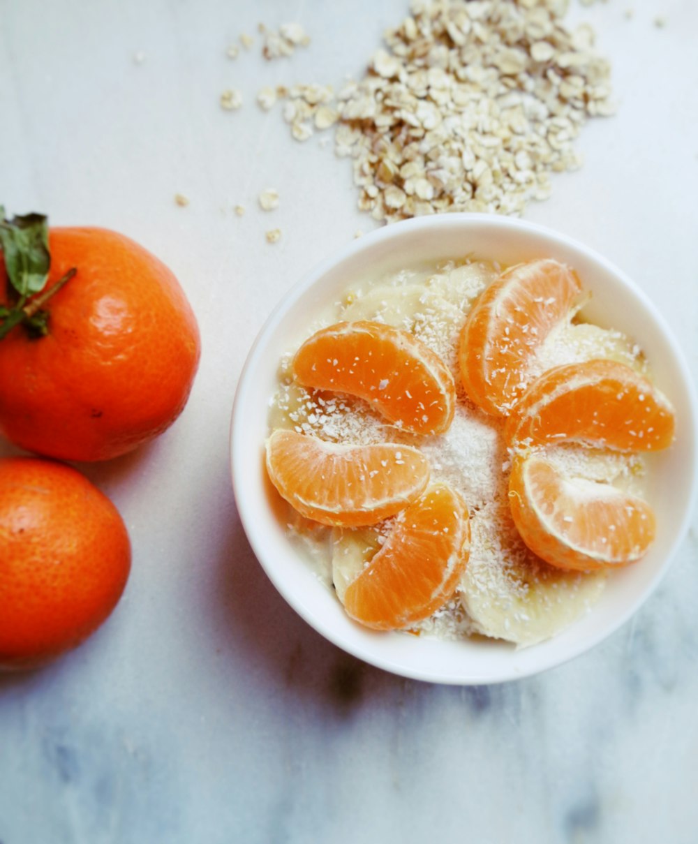 sliced orange placed on bowl