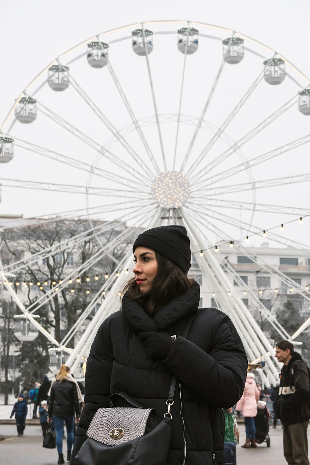 woman standing near Ferris wheel