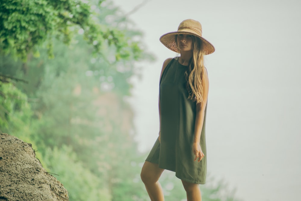 woman standing beside rock photograph