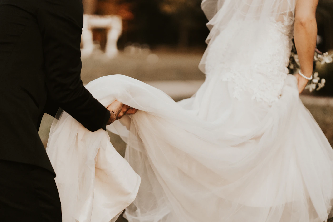 Wedding vendor gratuity guide for couples — A wedding planner reviewing a timeline with a couple, ensuring a smooth day.