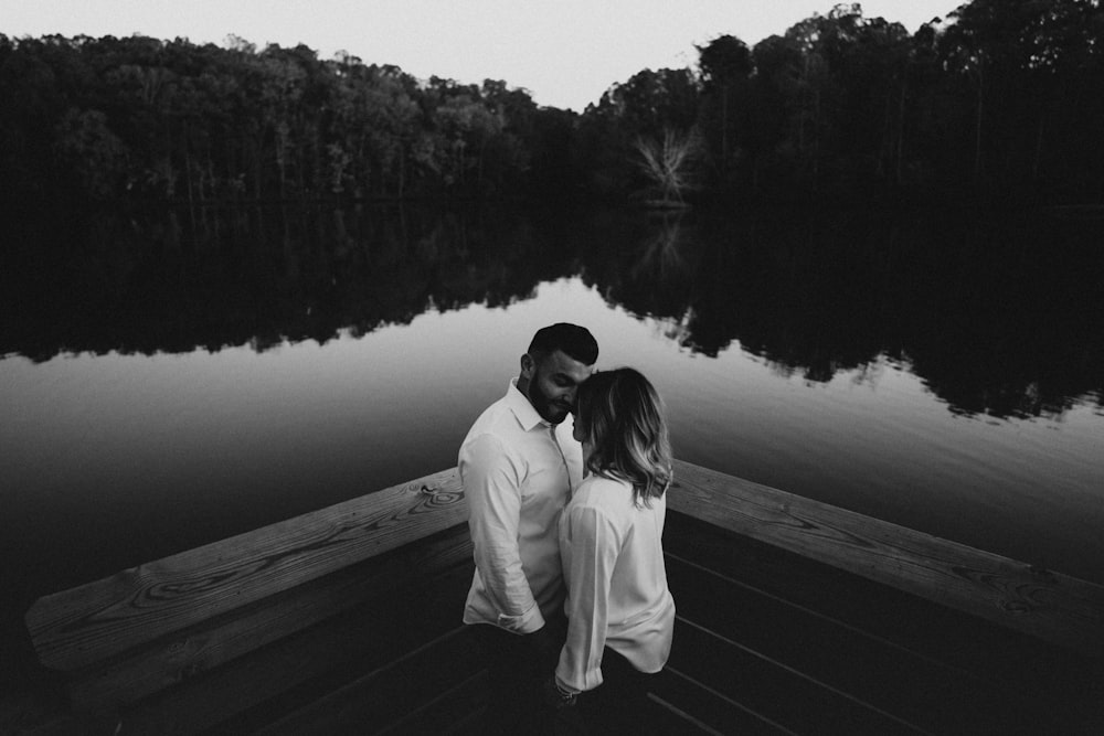 couple facing each other in greyscale photography