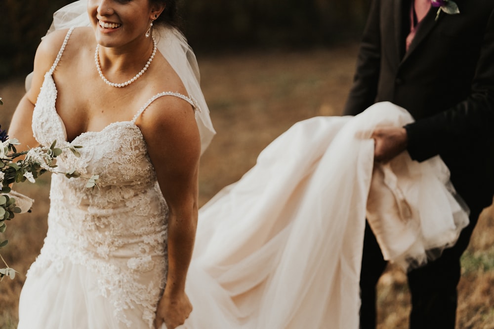 man holding women's white wedding gown