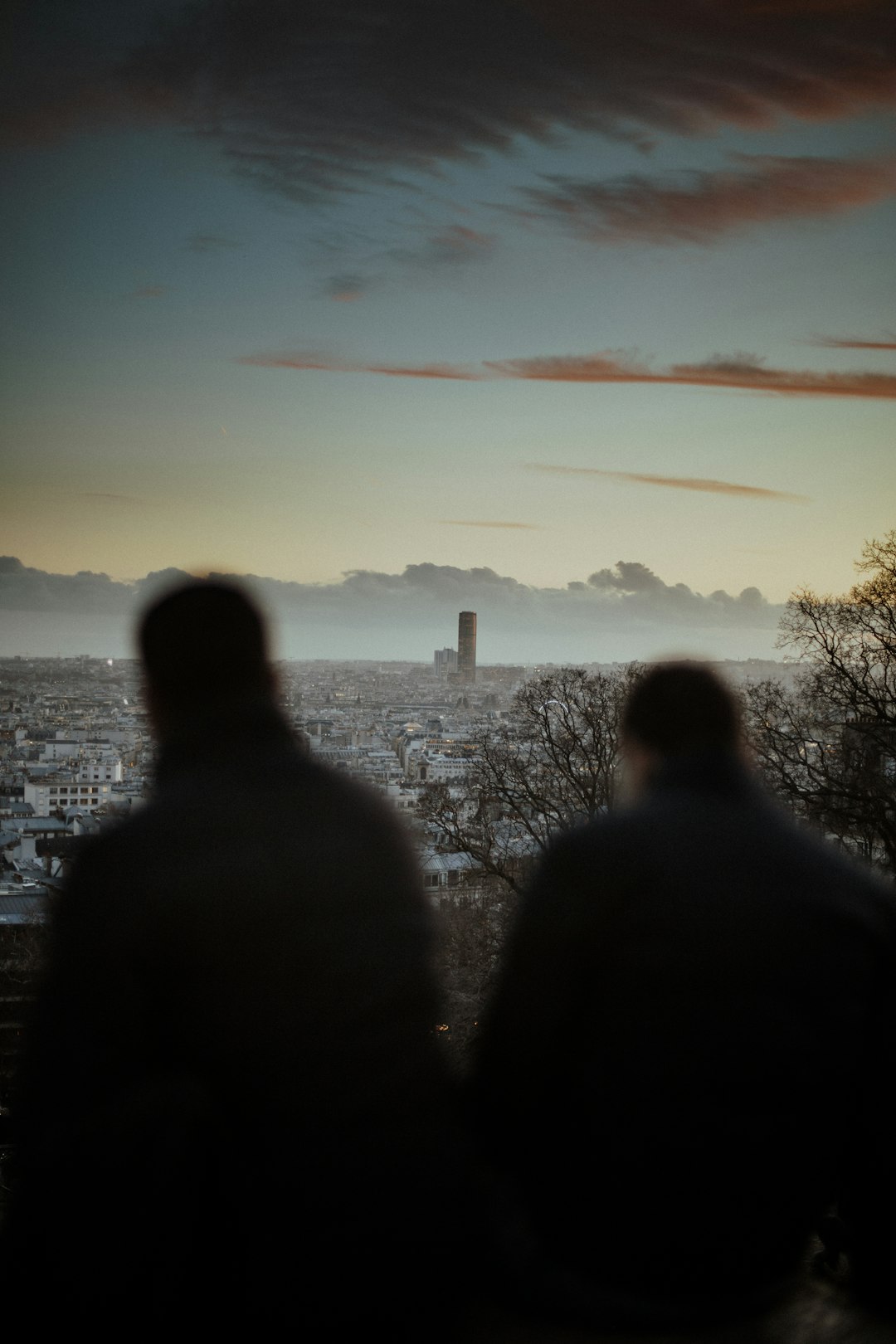 two man standing beside fence