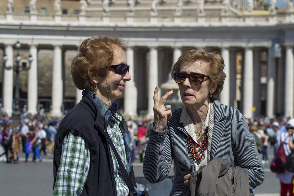 two woman taking in the street