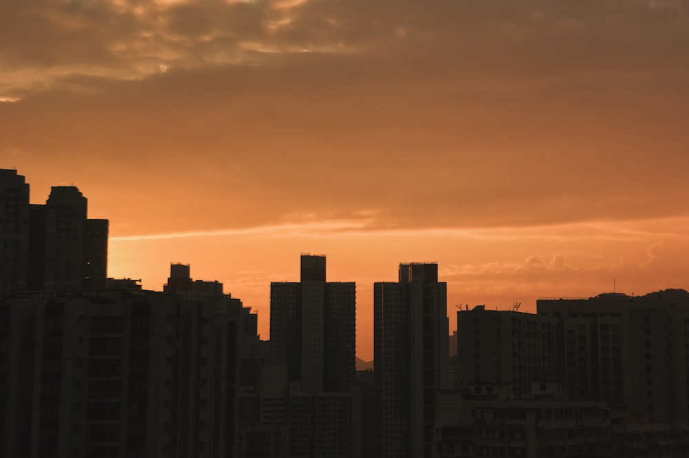 silhouette of high-rise building during golden hour
