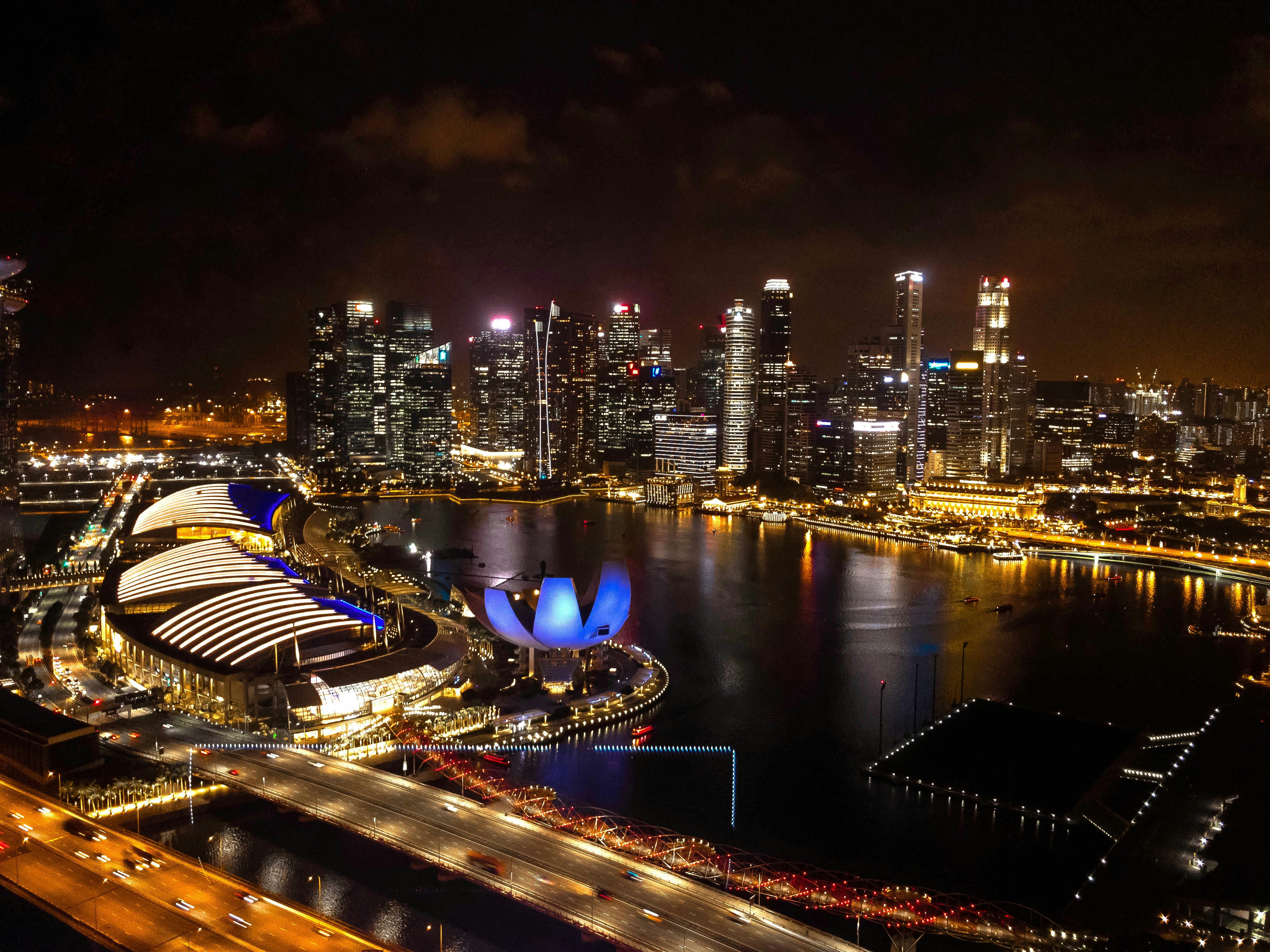 aerial photography of Singapore buildings during nighttime, This photo was taken on the ride of the SingaporeFlyer, this is a ferris wheel in Singapore. The view from there is astonishing! This photo is always a reminder of the nice city of Singapore.