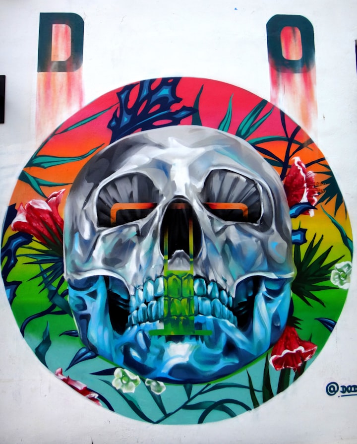 A gray-and-blue skull illustration painted on a wall, matching the skull silhouette of flash design №003