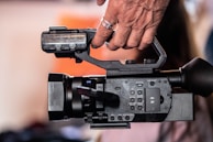 Close-up of a cameraman filming a breaking news segment on aam tv.