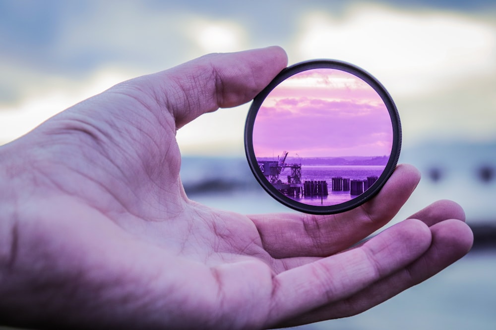 hand holding lens focused on coastline