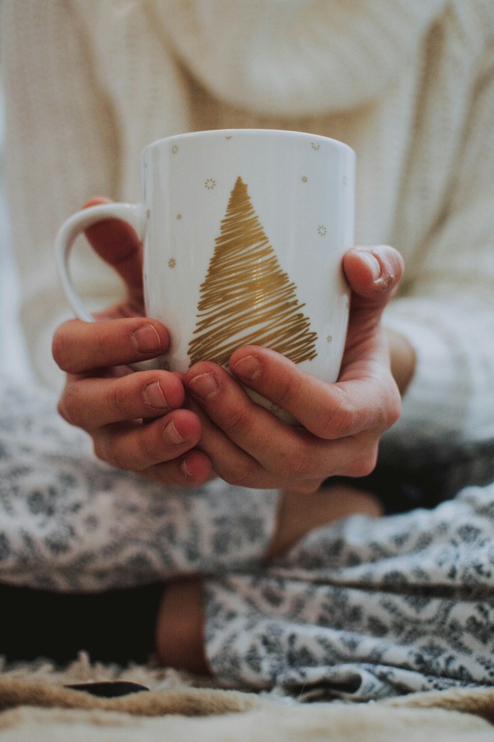 person holding white mug