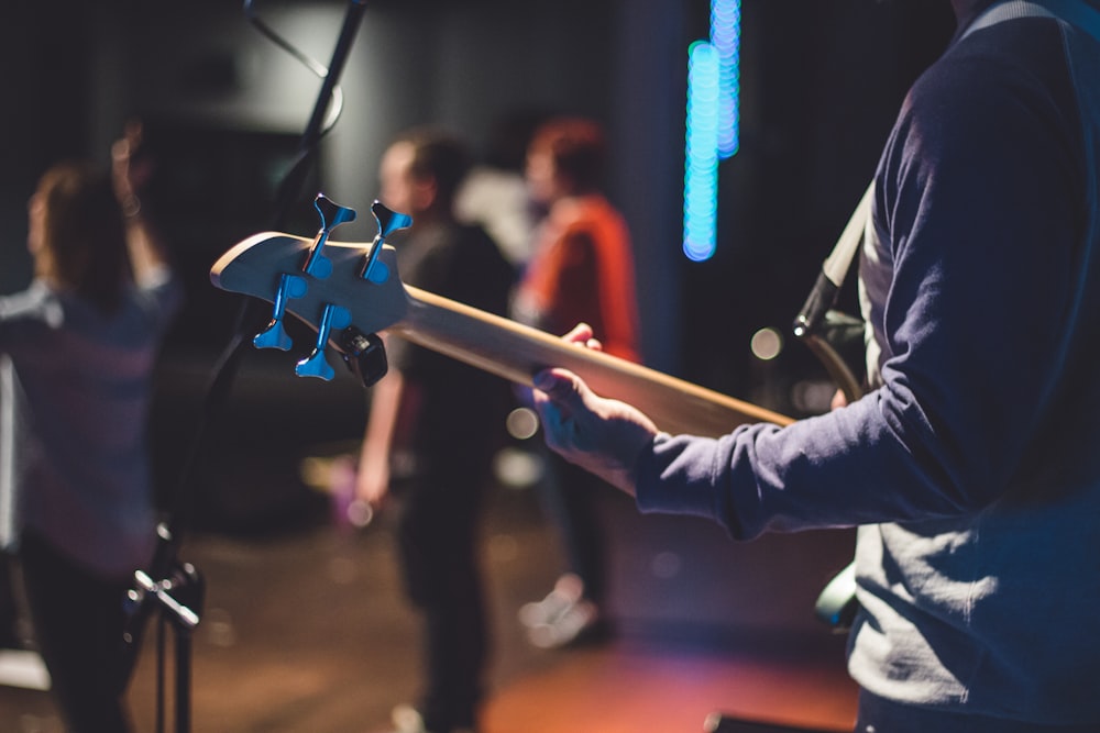 man holding bass guitar