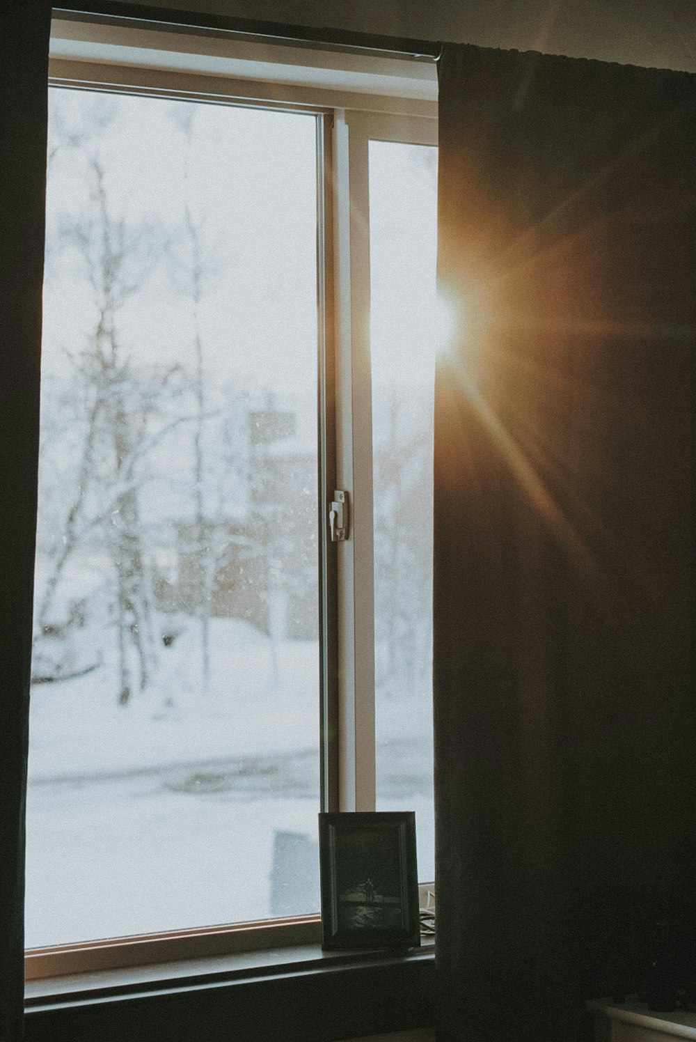 black photo frame beside window