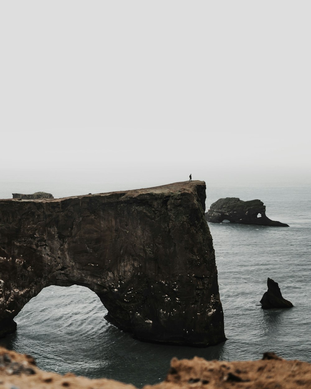 gray rock on body of water