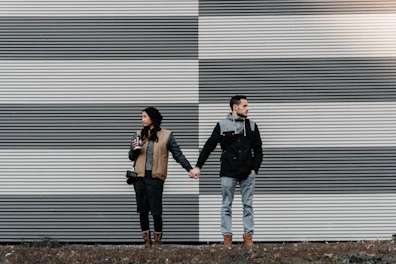 man and woman holding each other's hands