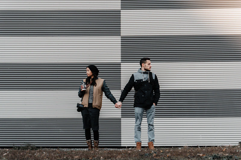 man and woman holding hands affectionately