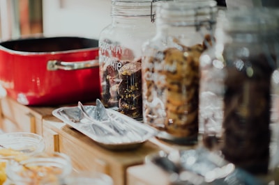 An elegant display of cookie jars on a wooden table.
