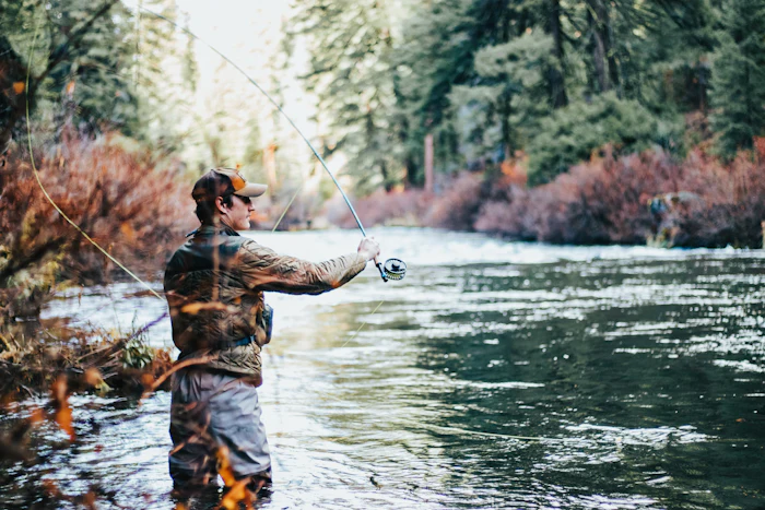 Fly fisherman casting at dusk