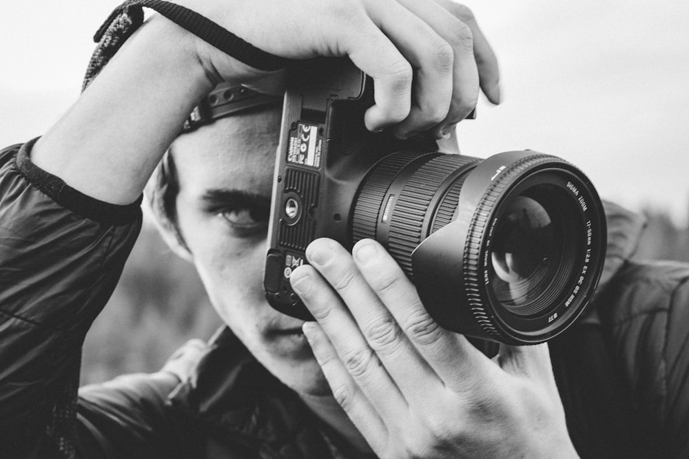 man holding DSLR camera